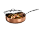 Copper pan with lid, filled with roasted potatoes and zucchini.
