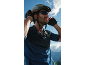 Man in cycling helmet, sunglasses, and gloves enjoying the view.