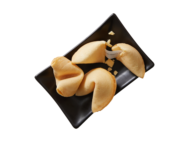 Fortune cookies on a black plate, one broken with a visible fortune slip.