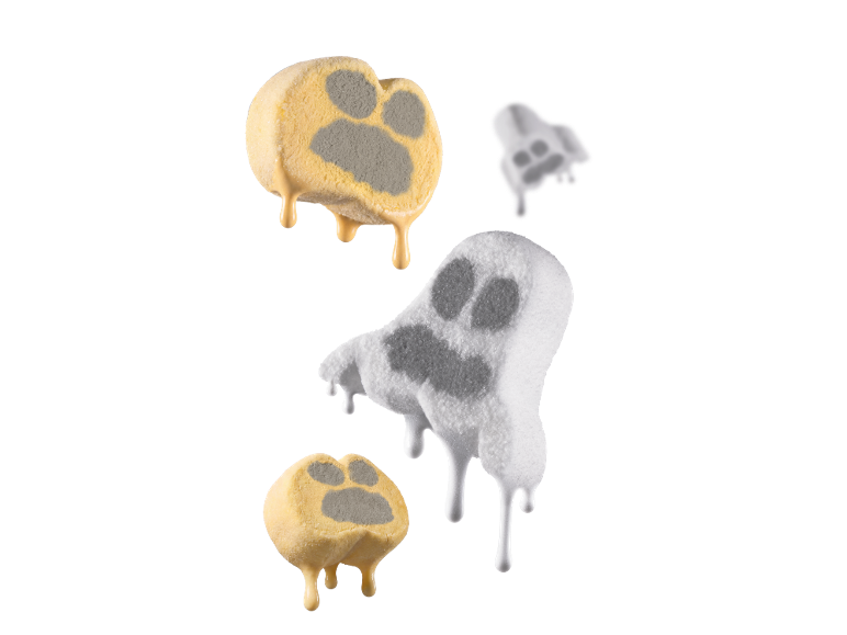 Melting paw print and ghost-shaped ice cream treats with smoke on black background.