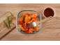 Marinated chicken wings with a basting brush and rosemary.