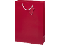 Red gift bag with a blank tag and white handles.