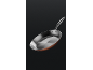 An elegant copper and steel frying pan with a long handle, against a dark background.
