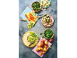 Overhead shot of various fresh vegetables, including carrots, potatoes, broccoli, and spinach, prepared for cooking.