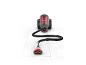 Compact cylinder vacuum cleaner with red dust container and black hose on white tiles.