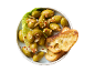 Marinated green olives with chili and garlic, served with toasted bread slices.