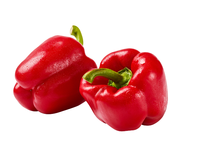 Two fresh red bell peppers with water droplets on a black background.