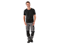 Smiling man in black t-shirt and grey and black work trousers.