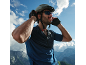 Man in cycling helmet, sunglasses, and gloves, with mountains in the background.