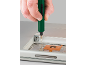 A green electric screwdriver is used to repair a laptop.
