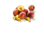 Fresh whole and sliced peaches on a white background.