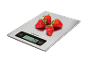 Digital kitchen scale with strawberries, displaying '74 g'.