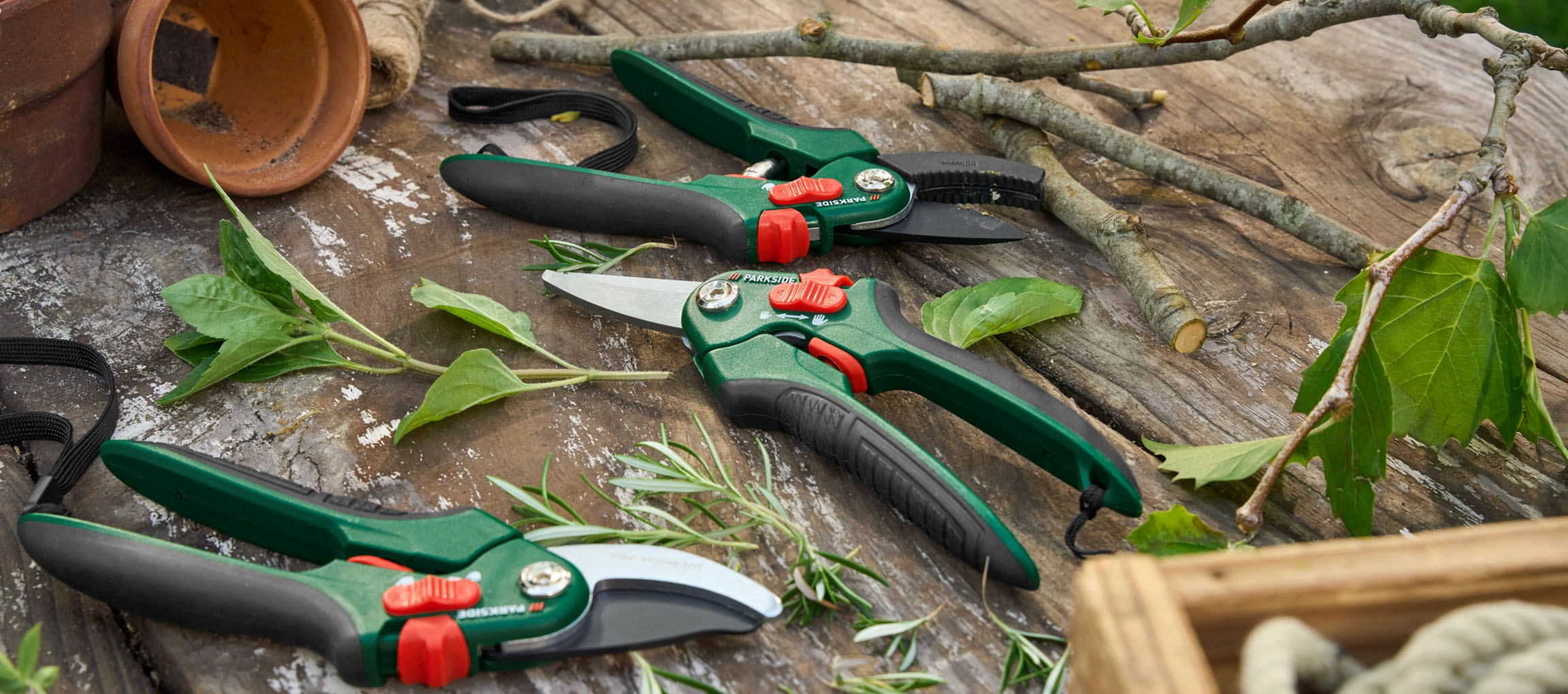 Three Parkside garden shears on a wooden table.