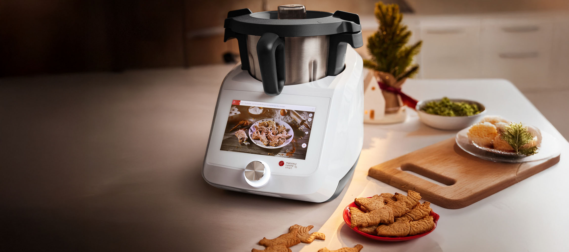 Monsieur Cuisine Smart kitchen machine with Christmas cookies and festive decor.