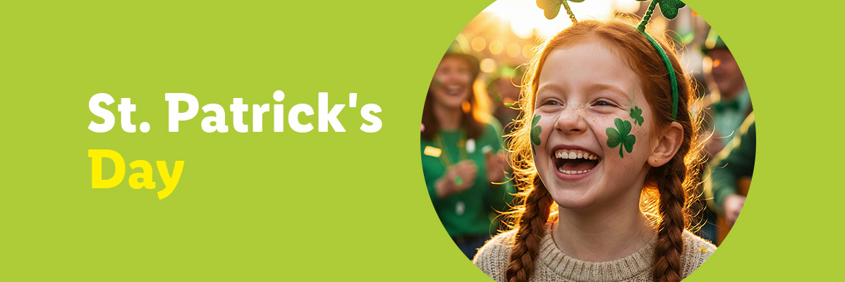 St. Patrick's Day text with a smiling girl wearing shamrock face paint and headband.