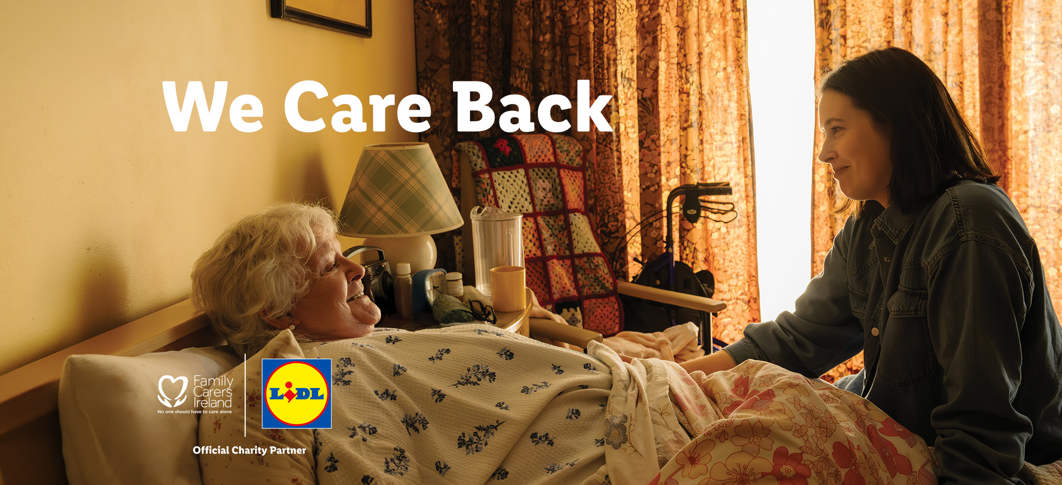 An elderly woman in bed smiling at a younger woman, with text 'We Care Back'.