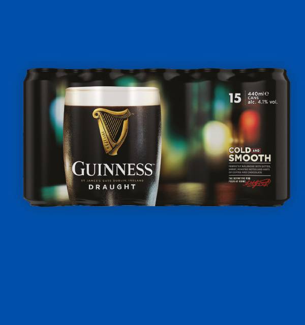 A glass of dark beer in front of a 15-pack of beer cans, labeled 'COLD AND SMOOTH'.