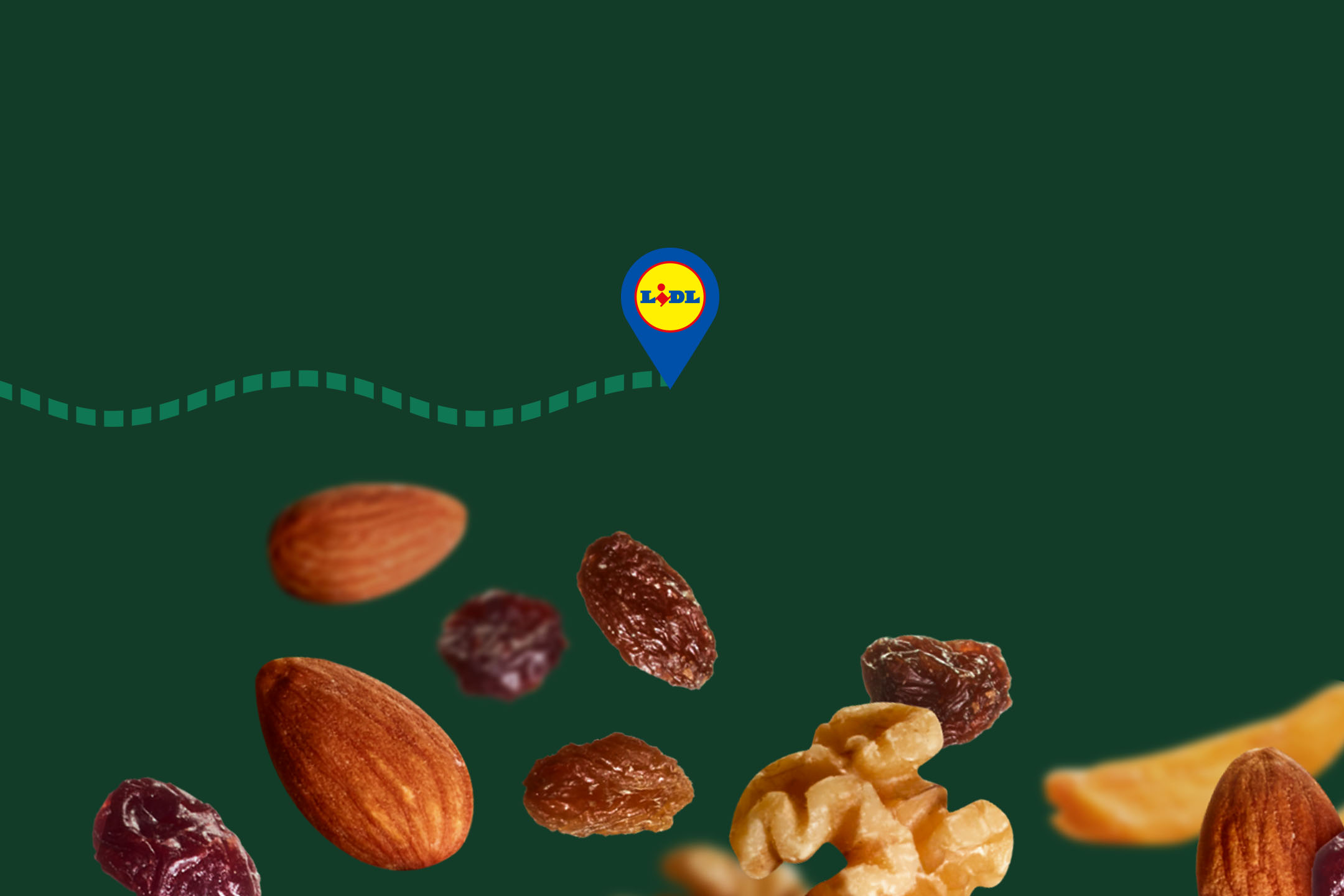 Nuts and dried fruits, such as almonds, raisins, and walnuts, on a green background.