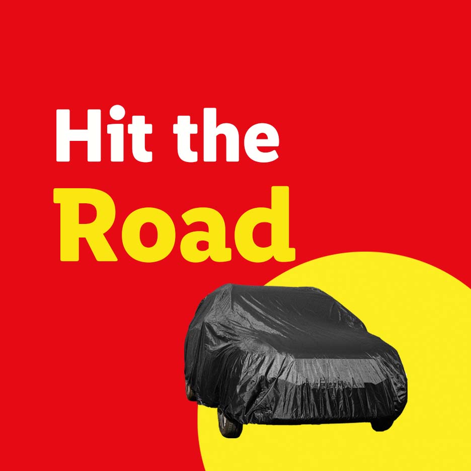 A car covered with a black car cover on a red background with yellow text that says 'Hit the Road'.