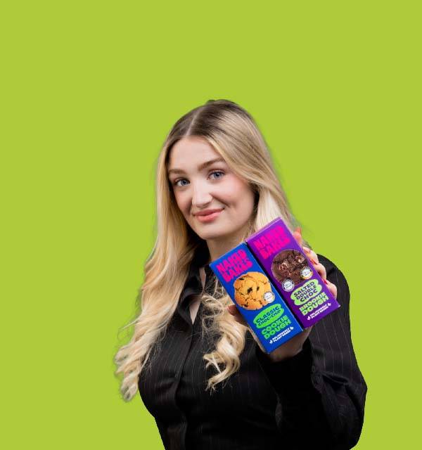 Woman holding two cookie dough boxes: Classic Choc-Chip and Salted Double Choc Brookie Dough.