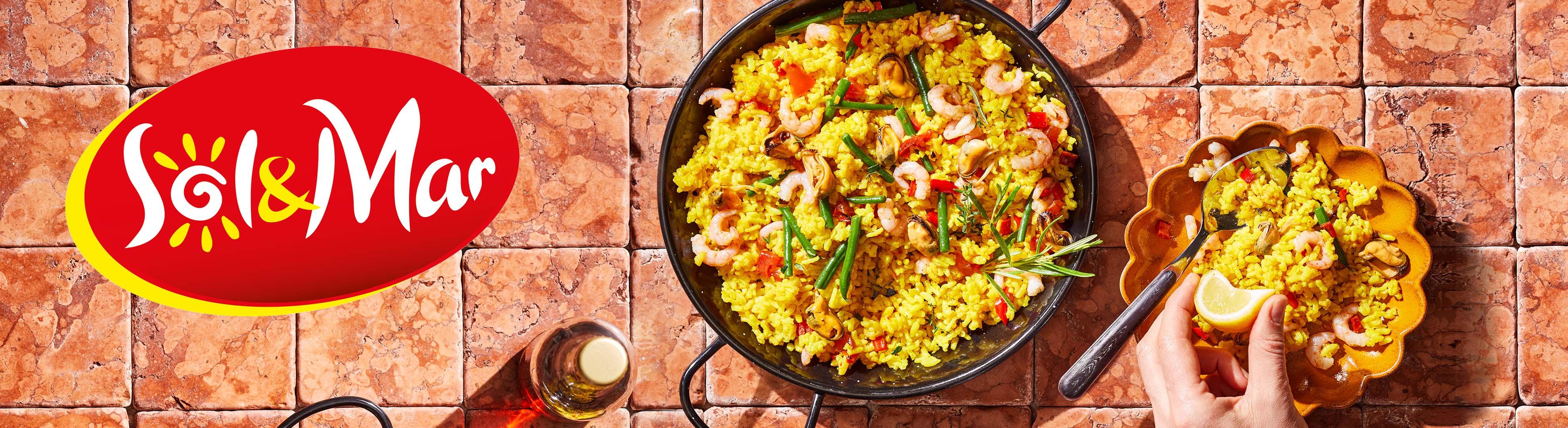 Sol & Mar paella with shrimp and mussels in a rustic setting.