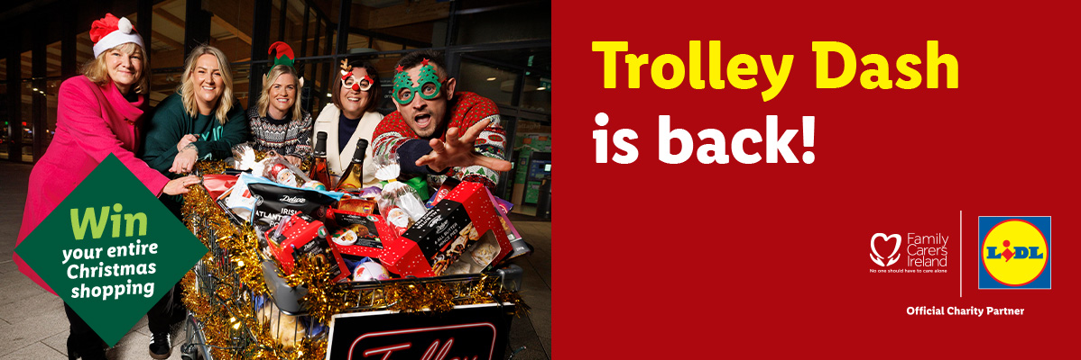 Five people in festive attire with a shopping trolley full of Lidl Christmas products, promoting 'Trolley Dash is back!' and 'Win your entire Christmas shopping' with Family Carers Ireland.