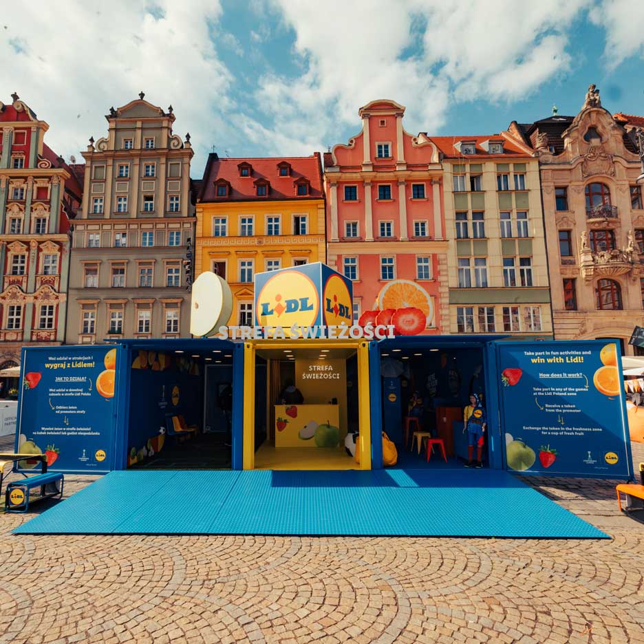 A Lidl fruit and vegetable themed installation, with games and activities, in an urban square.