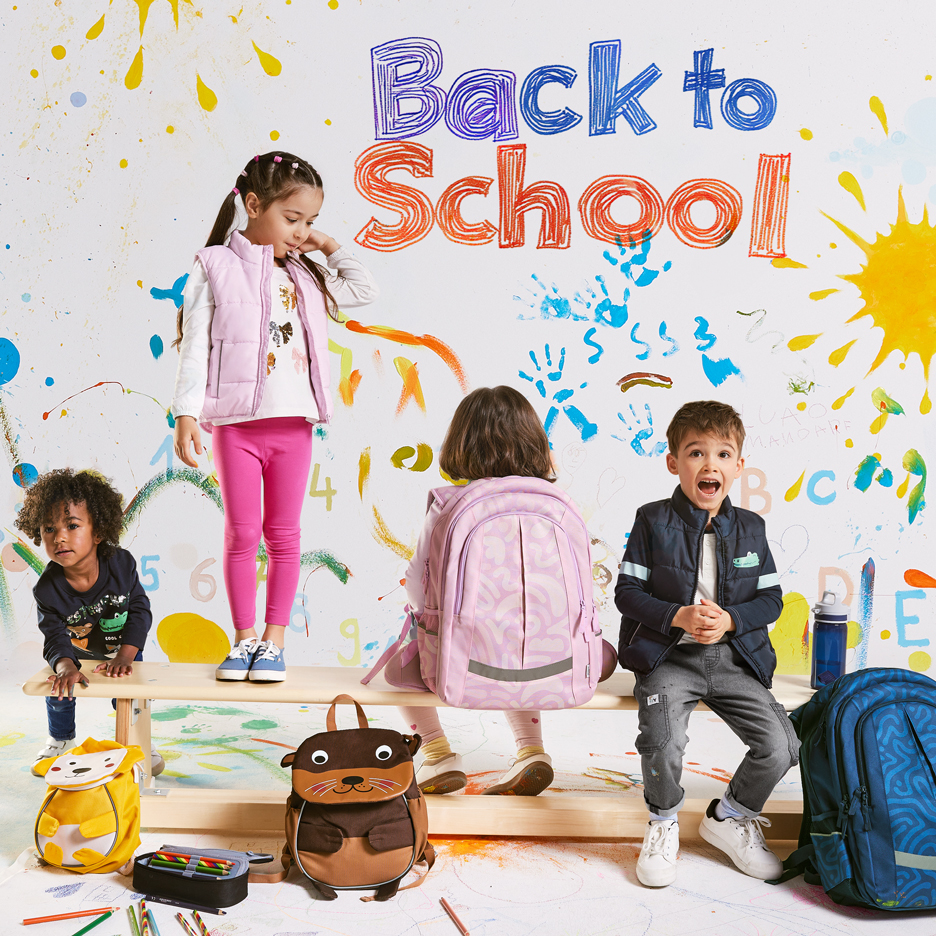 Four children with backpacks and school supplies, with 'Back to School' text on a colorful background.