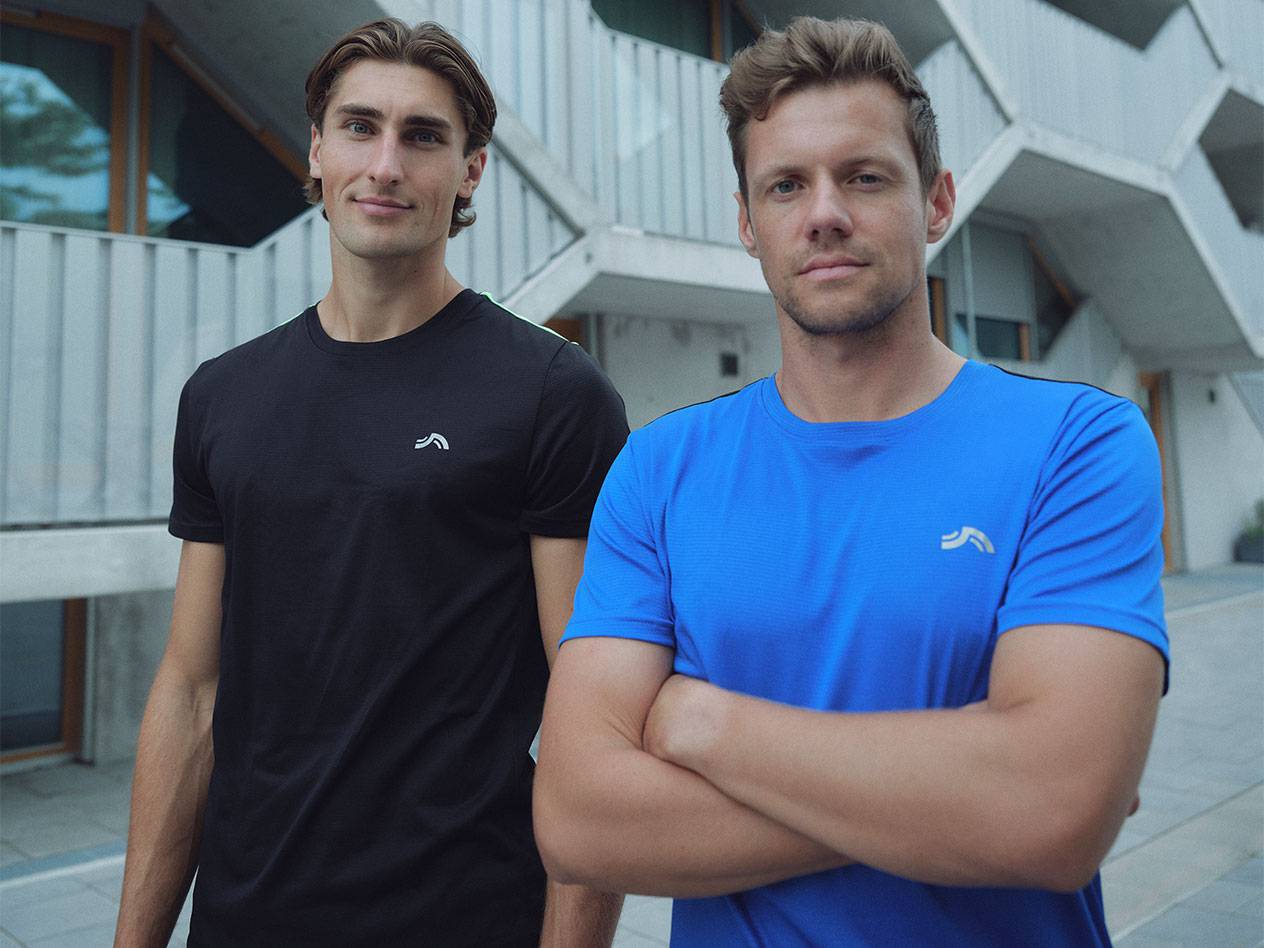 Two men in black and blue sports T-shirts with a logo.