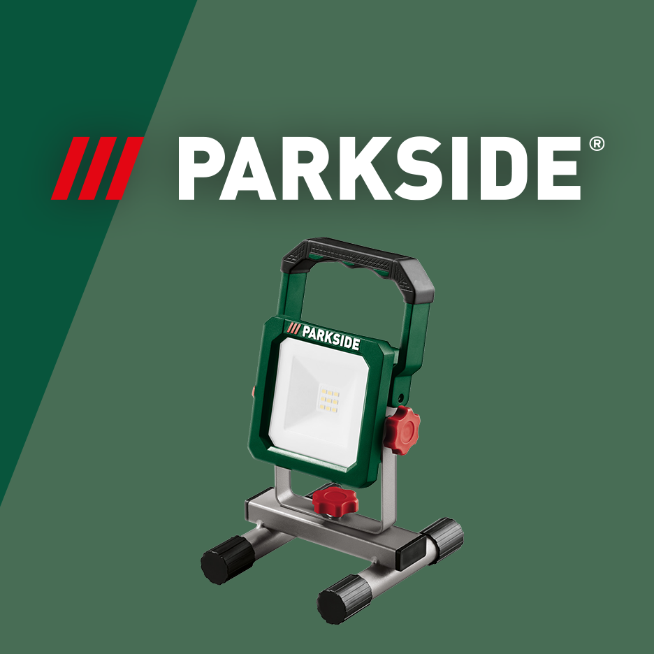 A green and white LED work light with a stand and handle, set against a dark green background.