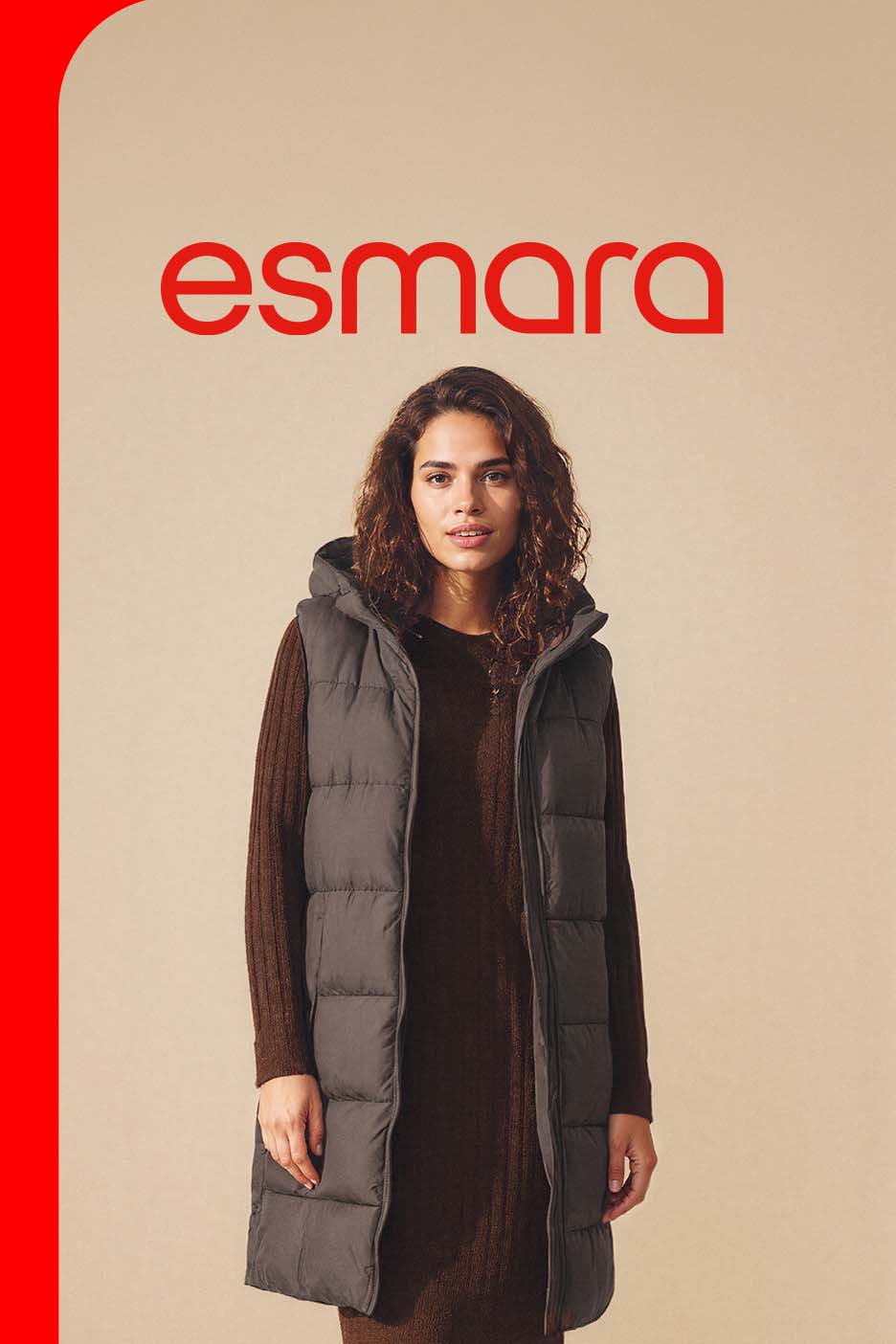 A woman wearing a long, hooded puffer vest over a brown knit dress.