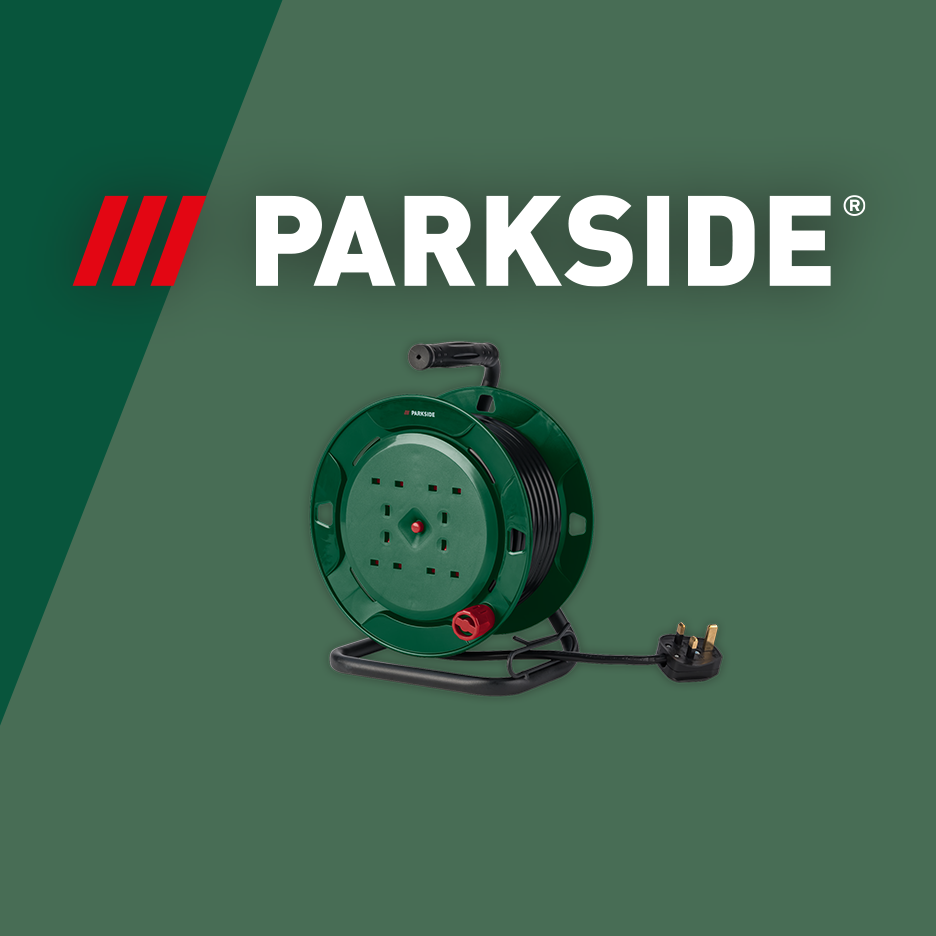 Green cable reel with four sockets and a UK plug on a dark green background.