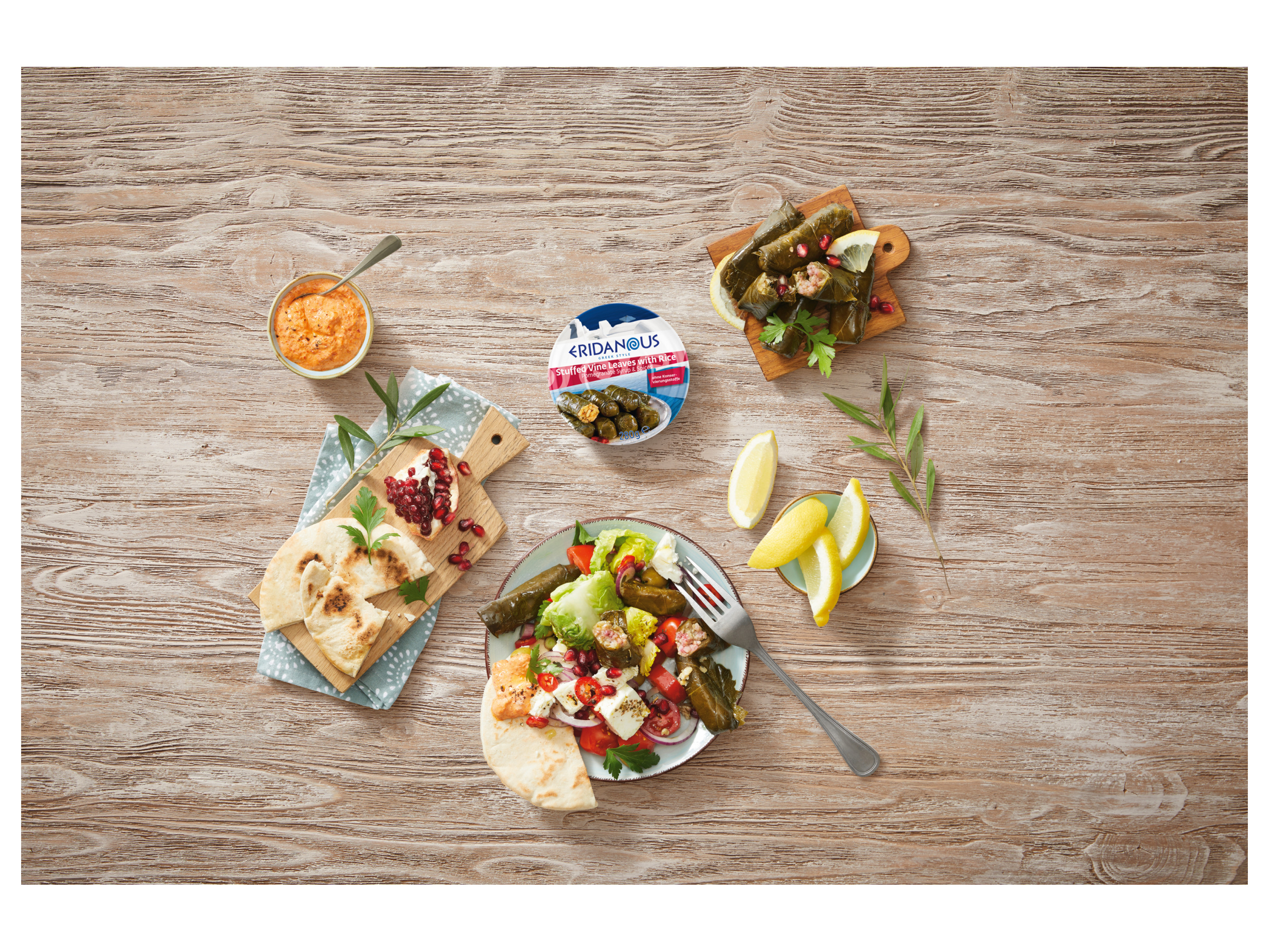 Eridanus Greek-style stuffed vine leaves with rice, served with pita bread, salad, and dips.