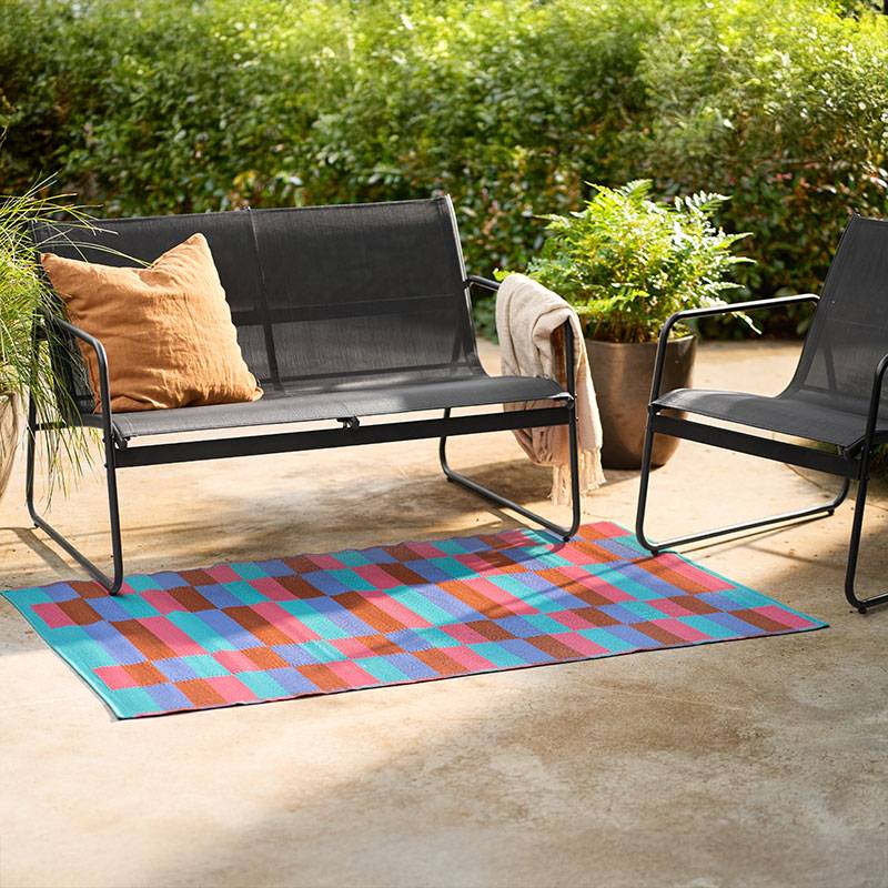 Outdoor furniture and geometric rug.